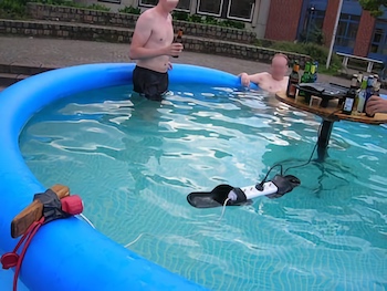 people in a pool with electronics