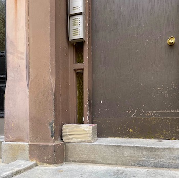 yellow page books sitting on doorsteps in the city