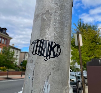 a think sticker on a city street poll for a thought about worrying