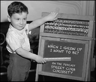 child pointing to blackboard about career choice