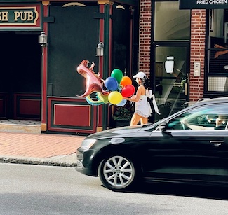 woman with balloons on street