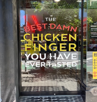 Restaurant door about chicken fingers in New York City
