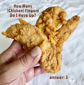 holding up three chicken fingers
