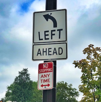 turn left traffic sign on pole