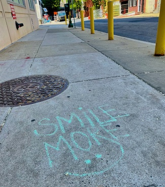 smile graffiti on a sidewalk