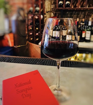 red wine at a bar for National Sangria Day