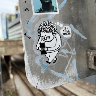 graffiti sticker on sign displaying outrage