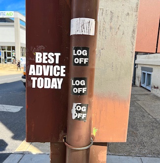 log off stickers on a street pole suggesting you take some time off.