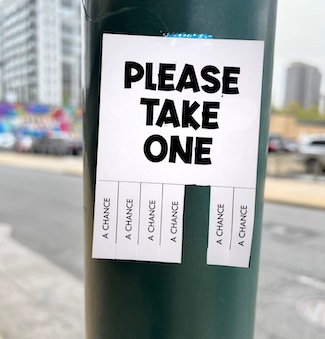 a paper tapes to a street pole, offering you to take a chance today.