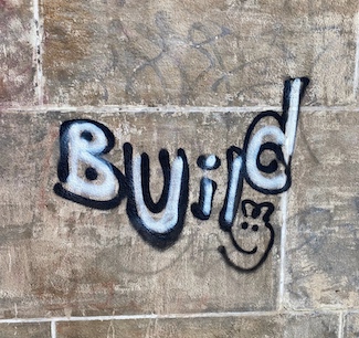 graffiti in philadelphia with the world build...to highlight weekend thoughts from the daily blog: www.caremoretoday.com