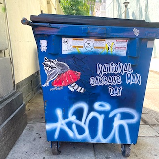 a fun raccoon graffiti on a blue dumpster for national garbage man day in June
