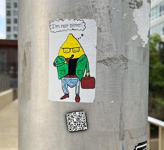 a sticker on a street pole with mister lemon saying he's not bitter; for the daily motivational blog from www.caremoretoday.com