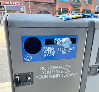 a water bottle in the wrong slot in a refuse can to highlight your lack of focus for the daily motivational blog from www.caremoretoday.com
