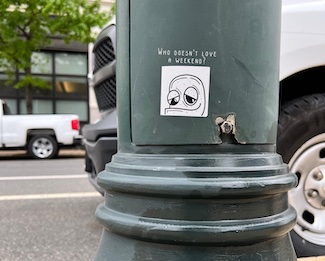 a sticker on a street pole suggesting to enjoy your weekend.  from the daily motivational blog www.caremoretoday.com