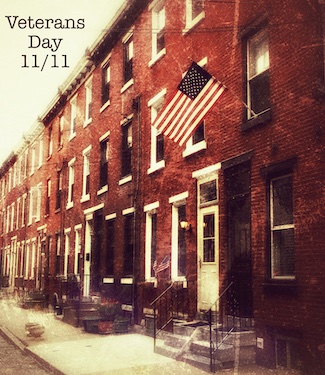 A street in philadelphia with American Flags for Veterans Day, from the daily thought blog www.caremoretoday.com