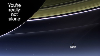 Planet earth as seen from the rings of Saturn about 900 million miles away in space