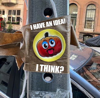 a sticker on a street poll, with a pumpkin sticking out its tongue about having an idea, from the daily thought blog www.caremoretoday.com