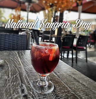 a full glass of red sangria on an outdoor table for national sangria day in december