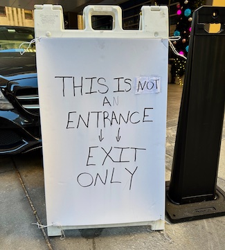 a poorly drawn exit sign at a luxury hotel shows a lack of attention to the brand