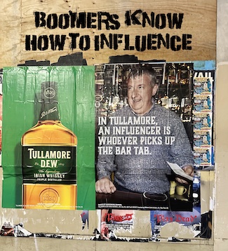 a worn outdoor poster for Tully whiskey on an empty building to highlight how influencers did they craft "back in the day", from the daily thought blog www.caremoretoday.com 
