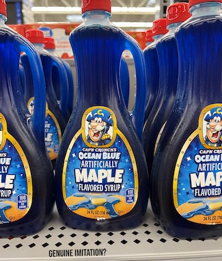 a few rows of bottles of artificial blue maple syrup, as an idea on authenticity in life and business.