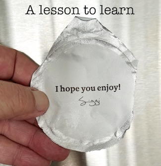 an aluminum foil life of a yogurt container with a message about that "little extra", a life or business lesson from the daily thought blog www.caremoretoday.com