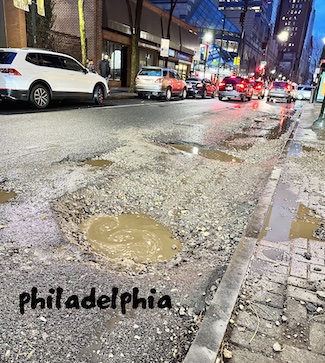 a pothole filled city street in downtown philadelphia in 2023