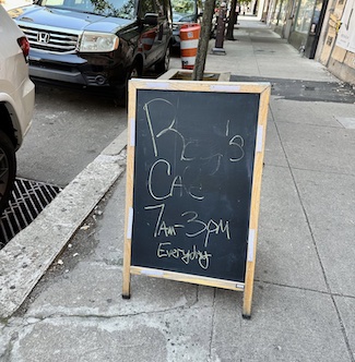 a business street sign where the name has been rubbed away, but still being used to promote the store