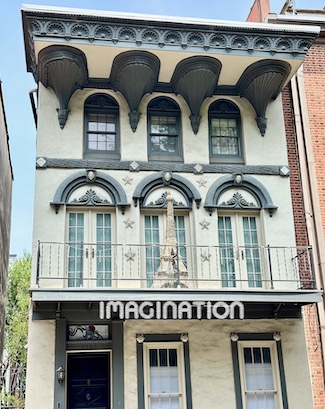a miniature replica of the Eiffel Tower on a second floor outdoor porch in Philadelphia