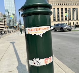a ripped and torn advertising poster on a city street pole