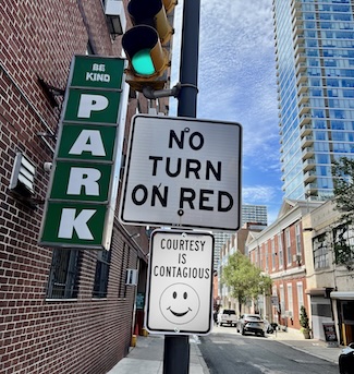 a city street sign highlighting courtesy