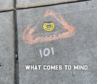 the number 101 spray painted on a city sidewalk...that make you ponder that number