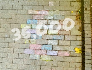 35 thousand written on a multi colored brick sidewalk