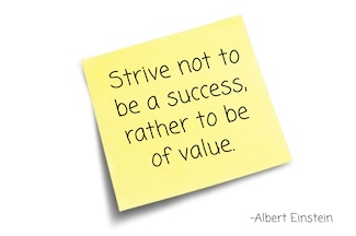 a yellow post it note with a quote about success from Albert Einstein