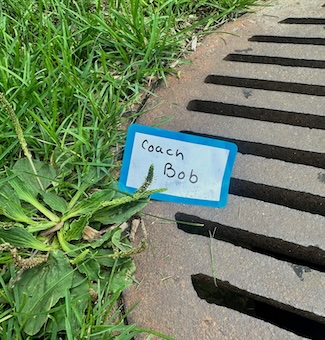a paper name tag found on the ground, with the name coach bob