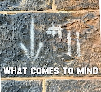 the number 11 painted with white paint on a stone wall  