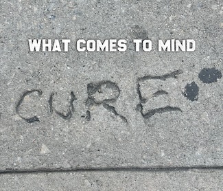 the word "cure" found in cement on a city sidewalk