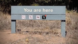 a sign at a trail head saying you are here