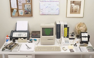 a typical office desk from the 1990's, with things replaced by technology on you phone