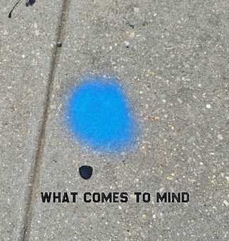 a blue paint dot on a city sidle that made imagination run wild