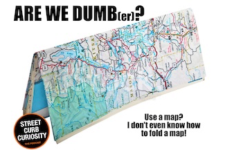 a folded road map as a symbol of things we used in the past and how we have gotten dumber without them