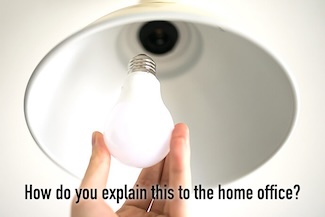 a hand screwing in a lightbulb into a lamp for this week's work accomplishment