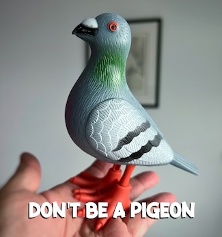 a wind-up plastic pigeon in a hand for a leadership thought