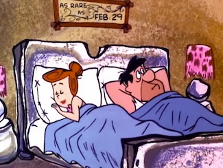 an image of Wilma and Fred in the same bed, with a bluish purple blanket, a rare thing to see on TV when it was popular. unique like leap year