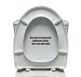 a toilet with a raised seat and a meaningful message about aim