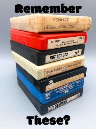 a stack of old 8-track music tapes to celebrate the invention of this music media in September of 1964