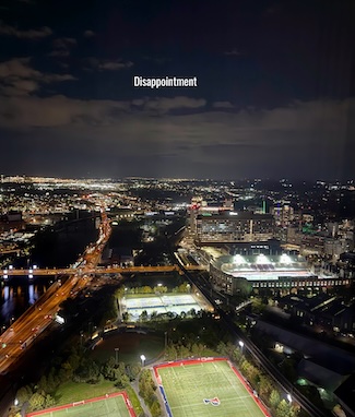 a southern horizon view of Philadelphia at night, with clouds blocking the view of a comet