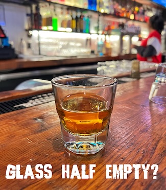 a shot glass of whiskey that's either half empty or half full as a question for any engineer