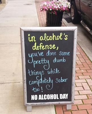 a fun sign on a street curb about being sober for no alcohol day in October