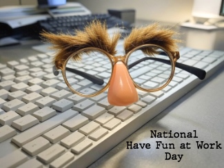 a pair of funny comedy glasses sitting on a keyboard for national have fun at work day
